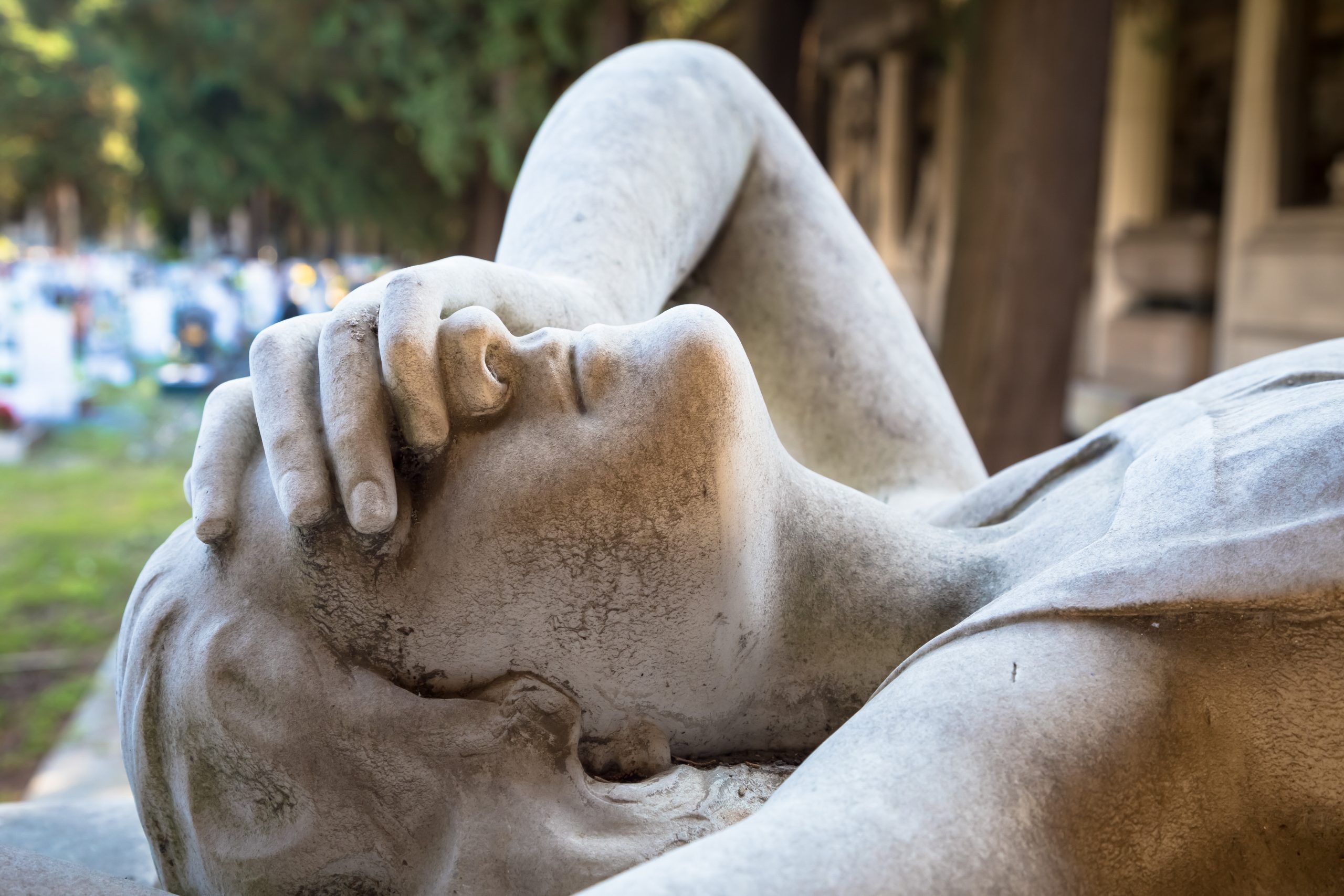 Statue of angel on a 1910 tomb located in an old Italian cemeter