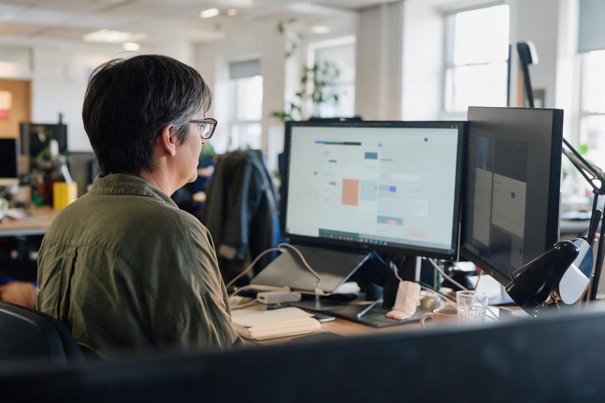 An EXPRE colleague reviewing and improving a client website across two monitors